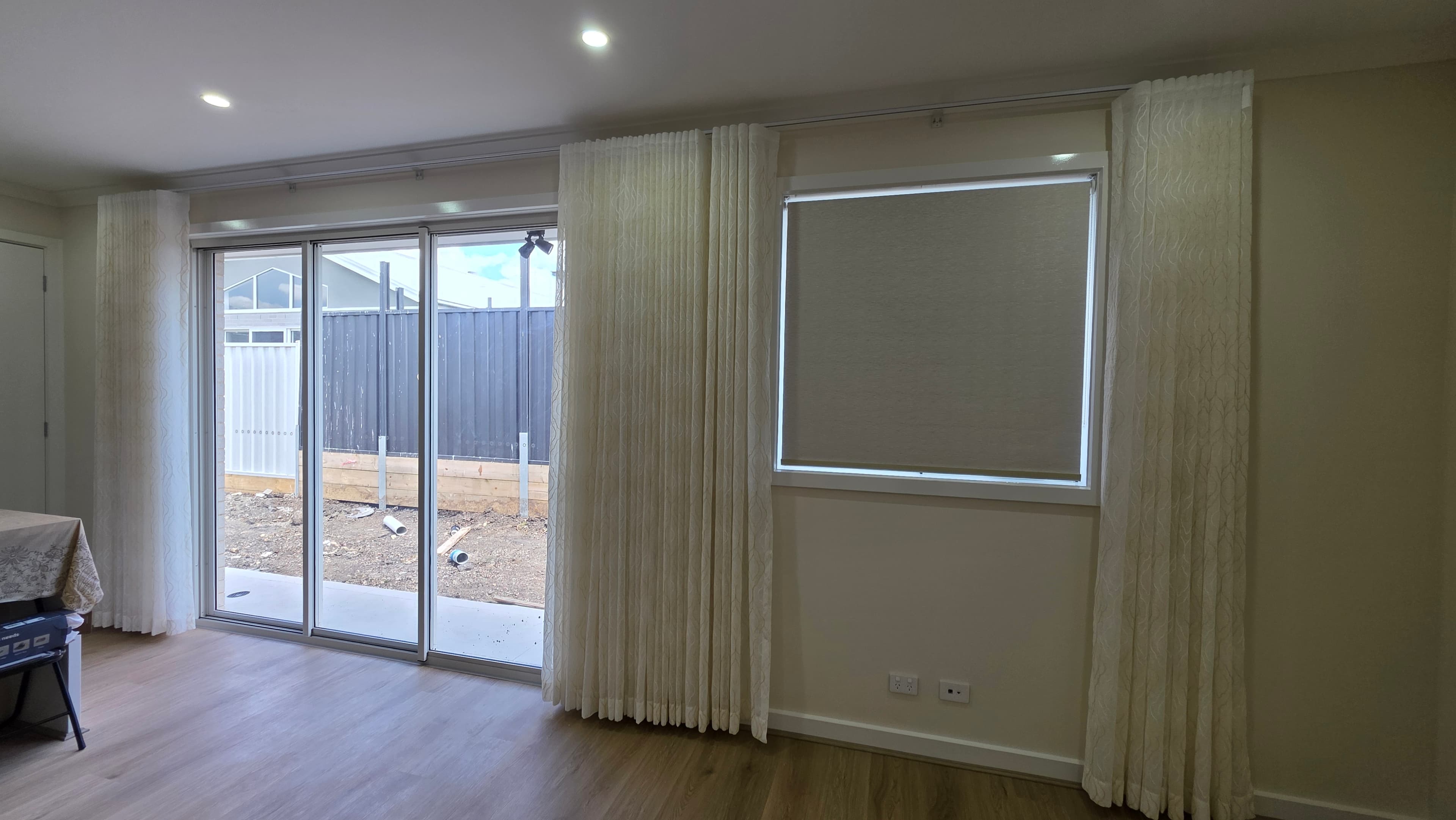 S-fold sheer curtains and roller blind installed in a Melbourne living room